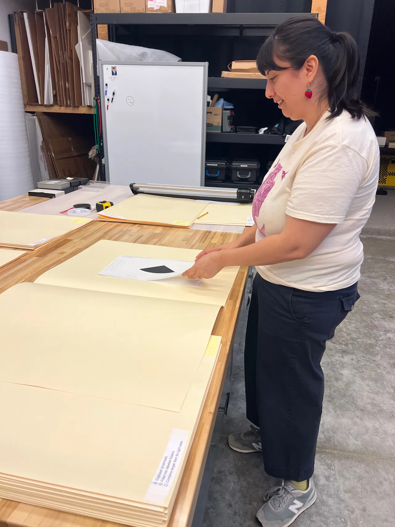 Jennifer transferring historical files into acid-free folders and folders into storage boxes