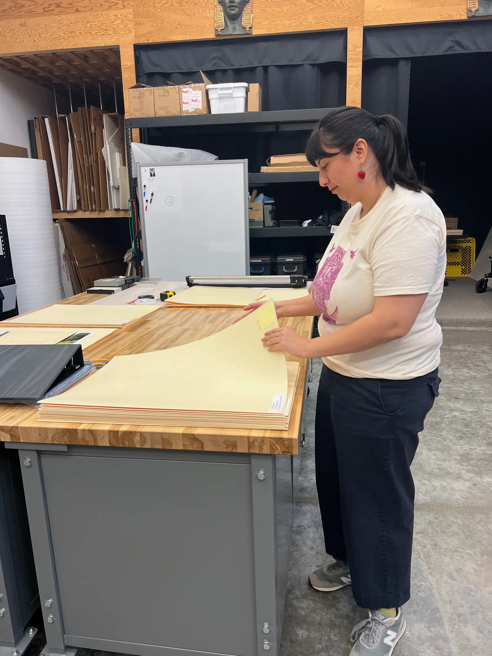 Jennifer reviewing Carlson fabrication folders and evaluating physical paper condition
