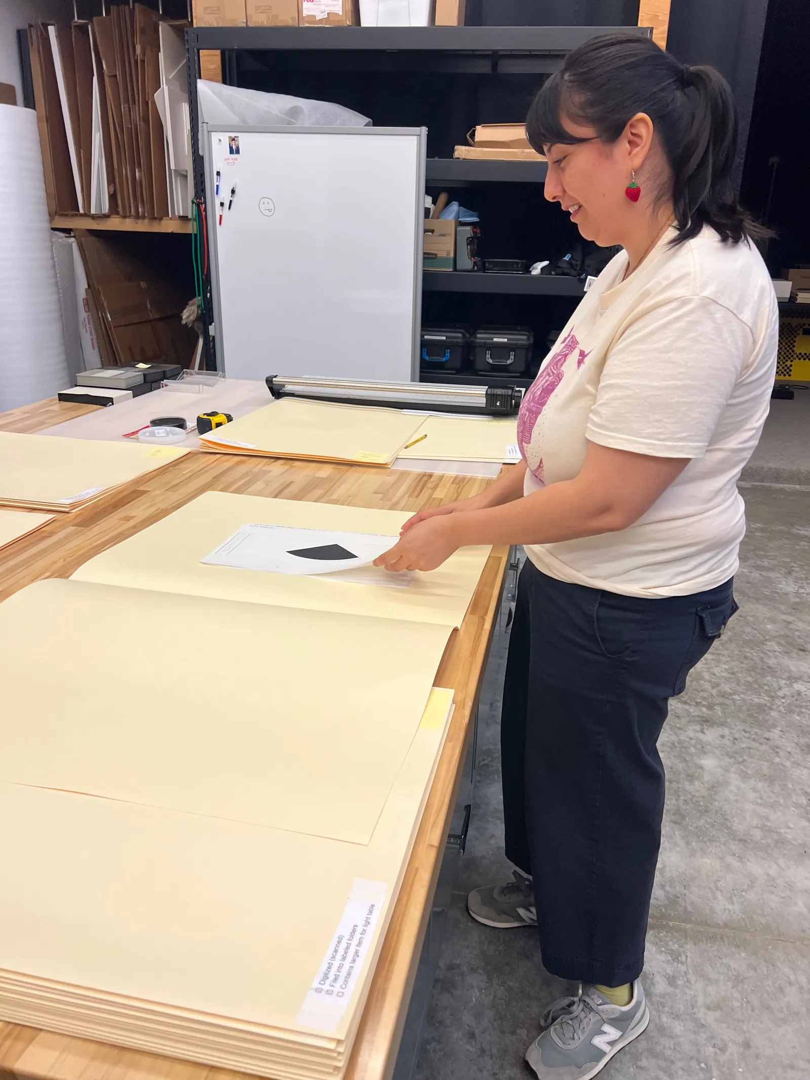 Jennifer transferring historical files into acid-free folders and folders into storage boxes