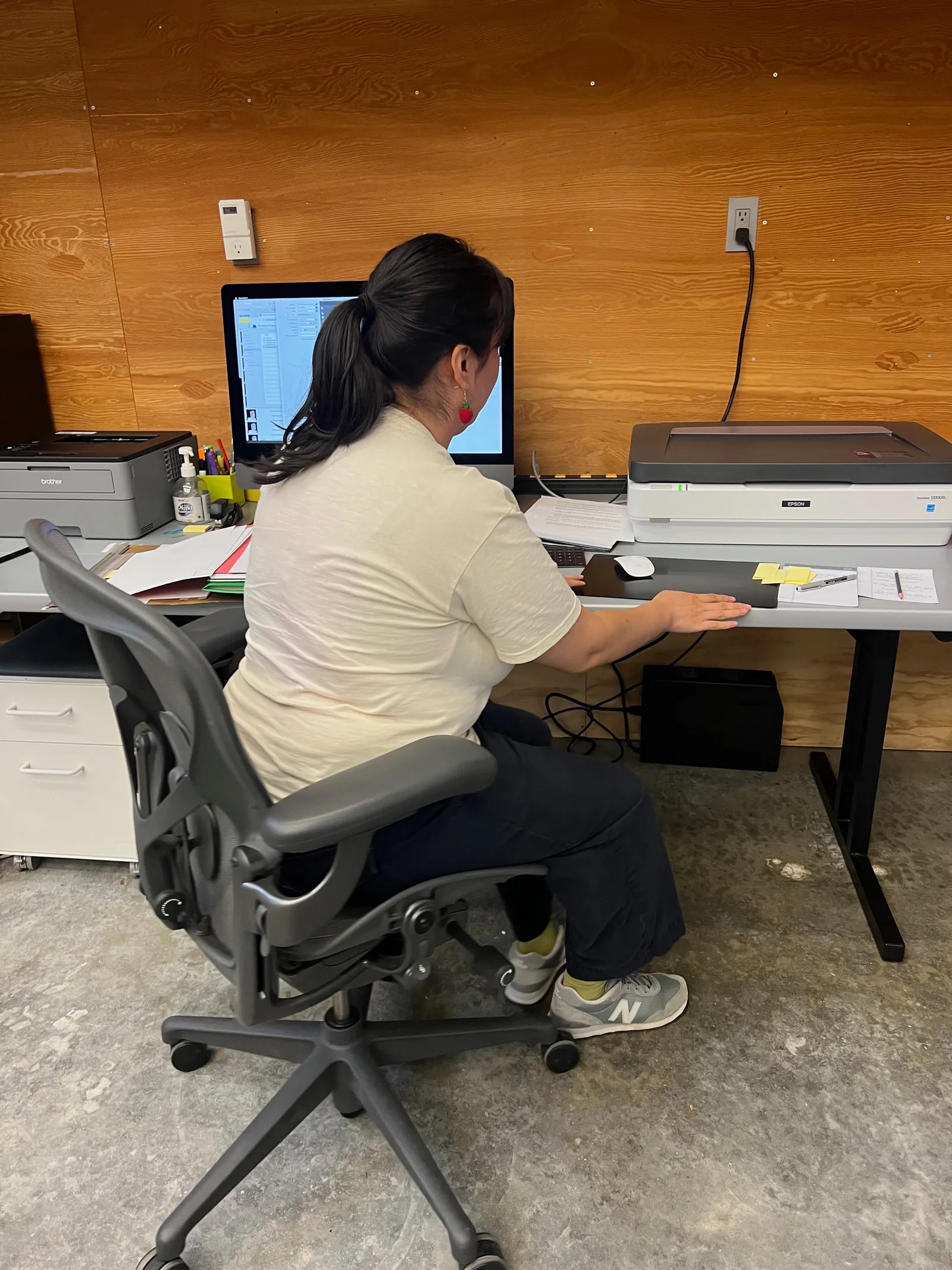 Jennifer operating a flatbed scanner to digitize archival letters
