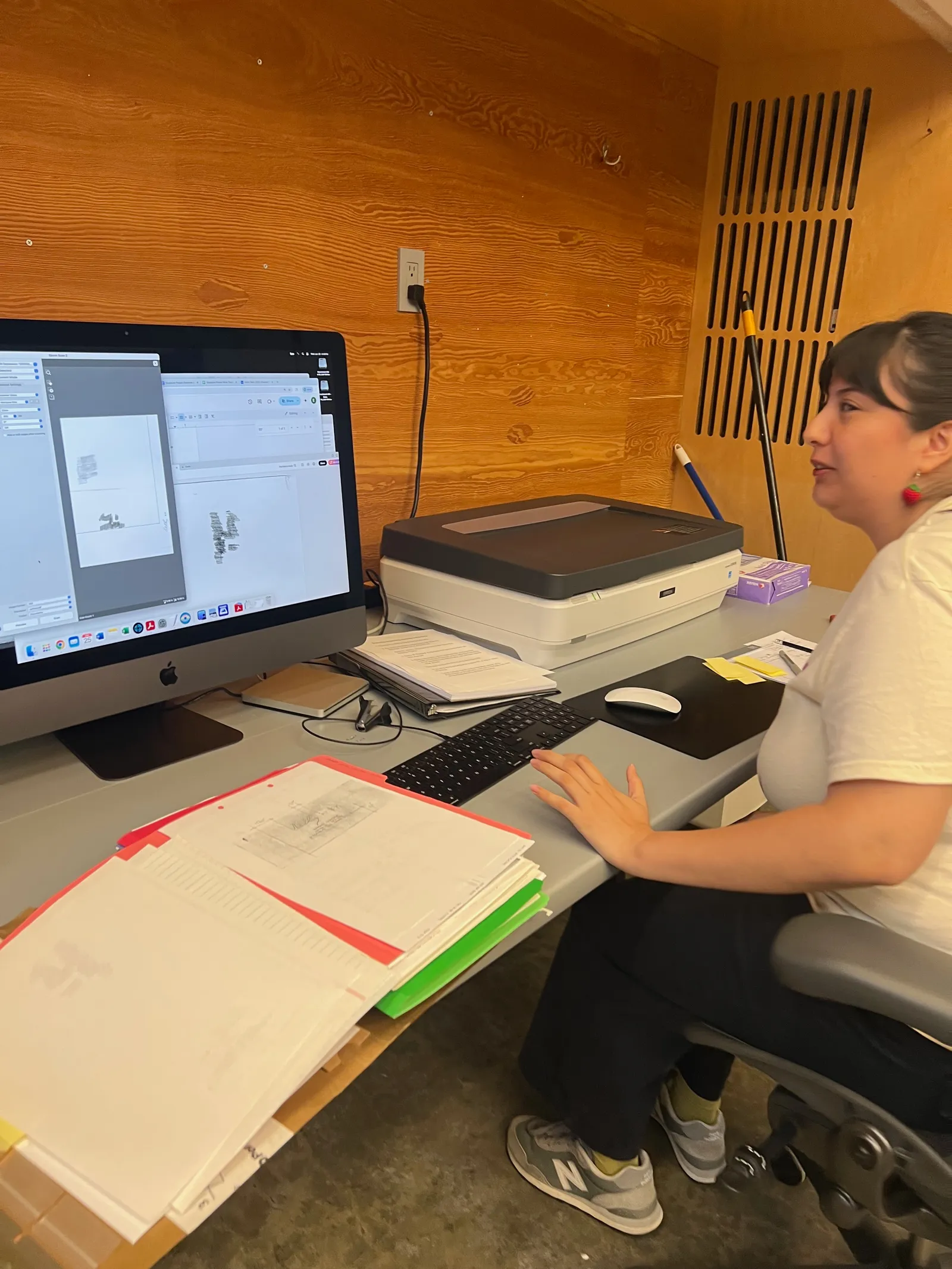 Jennifer entering metadata into an Excel tracking spreadsheet on a laptop