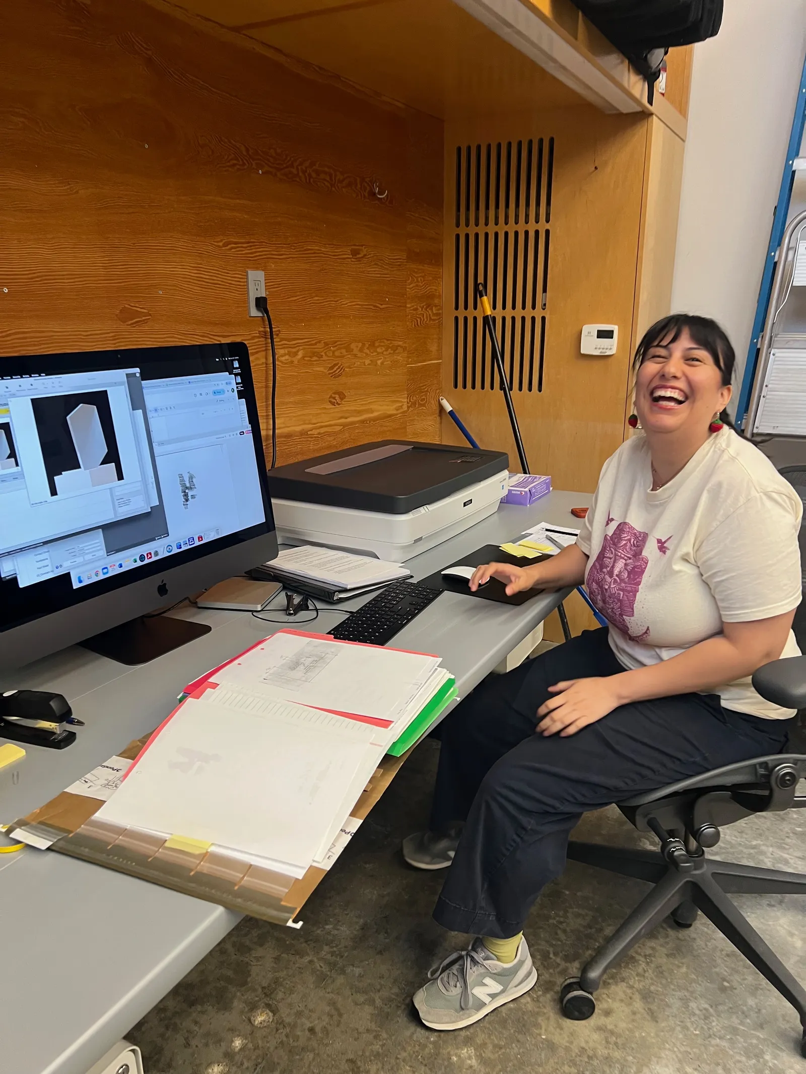 Jennifer feeding a document through a sheetfed preservation scanner